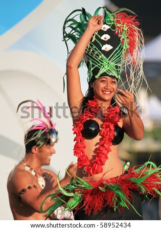 SHANGHAI - AUGUST 7: Dancers from Cook Islands, in colorful costumes, perform on stage during Cook Islands Oire Nikao Dance event at Shanghai World Expo 2010 on August 7, 2010 in Shanghai, China