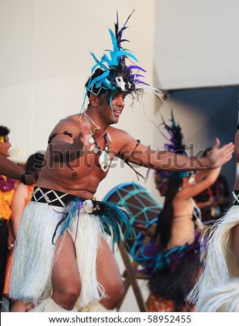 SHANGHAI - AUGUST 7: Dancers from Cook Islands, in colorful costumes, perform on stage during Cook Islands Oire Nikao Dance event at Shanghai World Expo 2010 on August 7, 2010 in Shanghai, China