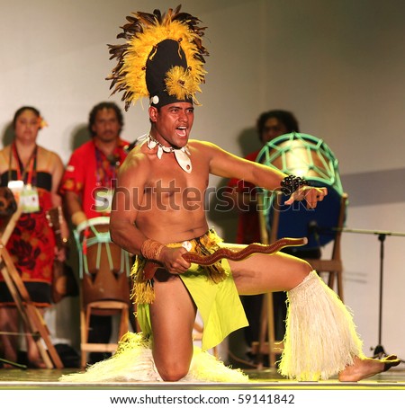 SHANGHAI - AUGUST 5: Dancer from Cook Islands, in colorful costume, performs on stage during Cook Islands Oire Nikao Dance event at Shanghai World Expo 2010 on August 5, 2010 in Shanghai, China