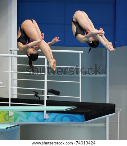 BEIJING - MARCH 25: Wu Minxia and He Zi of China warm up before the start of the Women\'s 3m Springboard Synchro Final of the FINA/Midea Diving World Series 2011 on March 25, 2011 in Beijing, China.