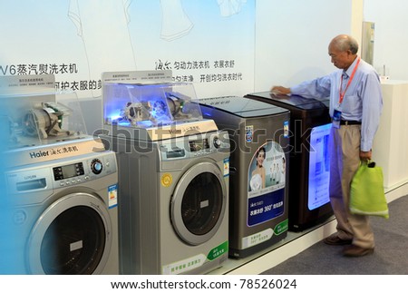 BEIJING-MAY20:A man takes a look at innovative home appliances during the 14th China Beijing International High-tech Expo(CHITEC) on May20,2011 in Beijing,China.CHITEC is a major National hi-tech Expo