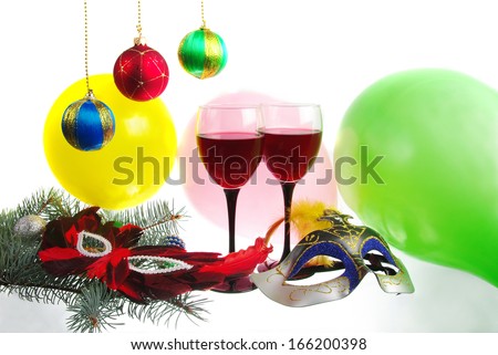 Christmas composition with glasses of  red wine, new year balls and masks