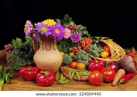 Vegetables and flowers on black  background