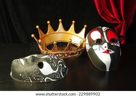 Crown, masks  and drapery on black