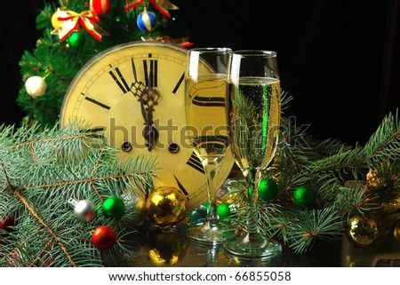 Two glasses of champagne and old clock.