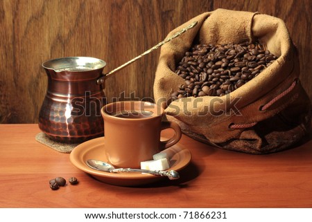 Cup of coffee and coffees sack full of beans