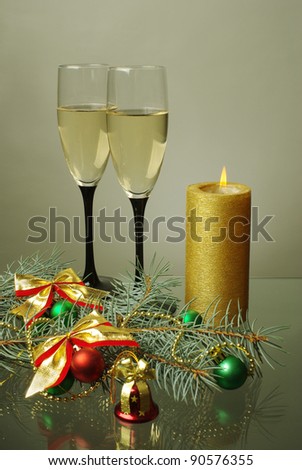 Two  glasses of wine, candle and decoration.