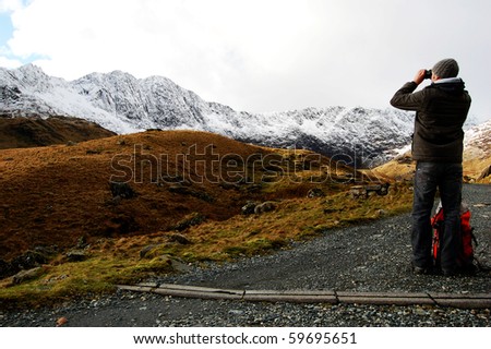 man contemplating beautiful mountain view