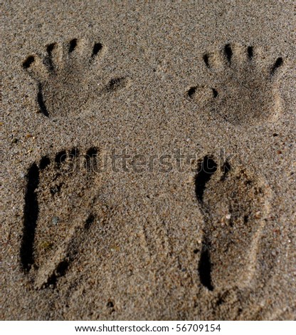 hand prints and footprints on the sand