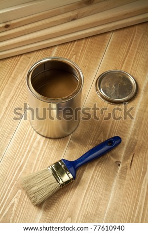 Painting tools on wooden floor.