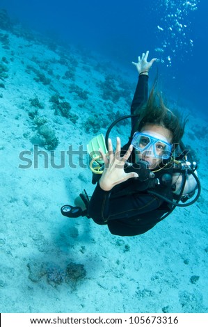 female scuba diver shows off her wedding ring