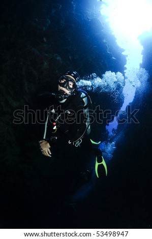 female scuba diver in underwater canyon