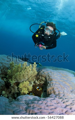 female scuba diver on amazing coral reef
