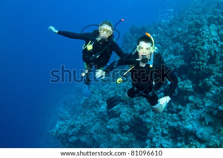 couple scuba dive on great dive site in the red sea