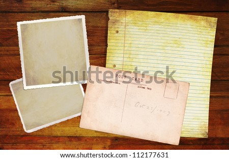 Wooden Background with blank old notepaper and photo blanks for your own content.