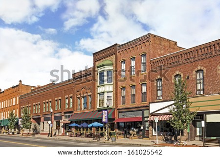 A photo of a typical small town main street in the United States of America. Features old brick buildings with specialty shops and restaurants. Decorated with autumn decor.  ストックフォト © 