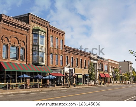 A photo of a typical small town main street in the United States of America. Features old brick buildings with specialty shops and restaurants. Decorated with autumn decor.  ストックフォト © 
