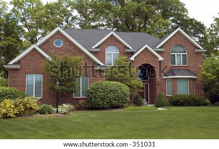 Brick home featuring five roof peaks.