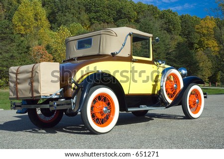 1931 Antique Model A with an unusual but authentic paint scheme.  The colors of the car match the fall pallet of the trees in the background.