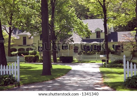 Sprawling Colonial style home. Mature trees and a white picket fence makes this an inviting entrance. Just one of many new house photos in my gallery.