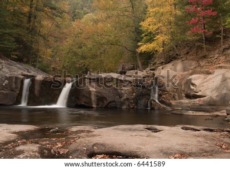 A small secluded waterfall in the forests of Tennessee. Nice autumn colors in the trees frame the beautiful scene.
