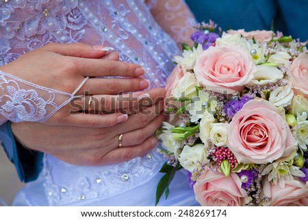 wedding bouquet flowers in hands of the bride