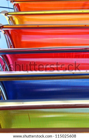 Colorful sun blinds for sale under a blue sky in Thailand.