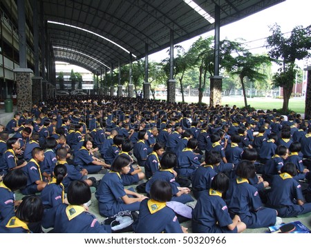 SEEKAN SCHOOL, BANGKOK, THAILAND- MAY 11: Students sit in morning assembly in the school yard. Seekan School, Don Muang in May 11 2005 in Bangkok.