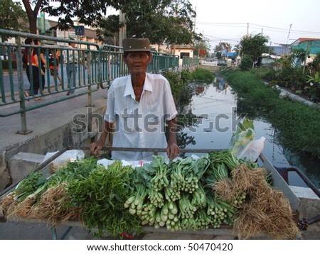 BANGKOK, THAILAND - JANUARY 25 : Old Thai man stands by the road selling Thai herbs January 25 2006 in Bangkok.