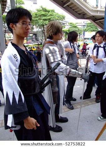 BANGKOK, THAILAND - AUGUST 4: Young models dressed as a samurai warrior and knight pose for photographers. MBK shopping center, August 4 2007 central Siam, Bangkok.