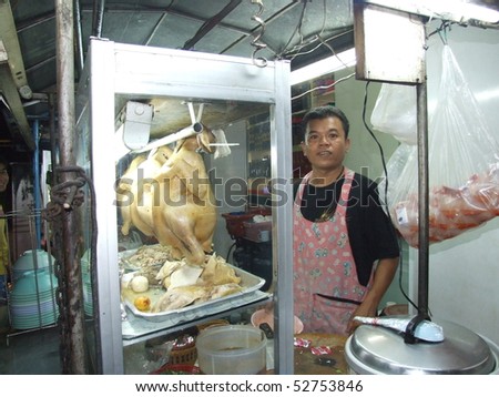 BANGKOK, THAILAND - MAY 17: Thai man stood behind his stall in an open restaurant May 17, 2005 in Bangkok.