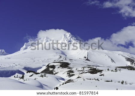 Mt. Hood covered in snow with ski lifts.