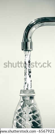 water running from a tap to a reusable plastic bottle on white background