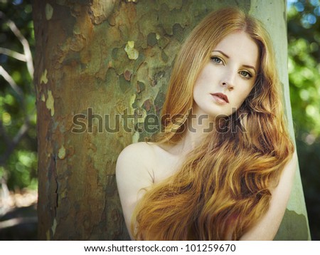Fashion portrait of young naked woman in garden. Beauty summertime