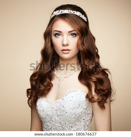 Portrait of beautiful sensual woman with elegant hairstyle. Wedding dress. Fashion photo