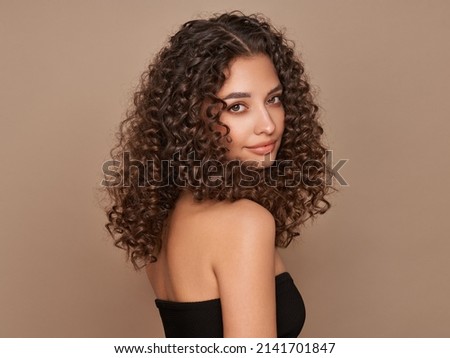 Fashion studio portrait of beautiful smiling woman with afro curls hairstyle. Fashion and beauty Сток-фото © 