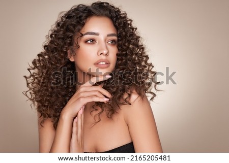 Fashion studio portrait of beautiful smiling woman with afro curls hairstyle. Fashion and beauty Foto stock © 