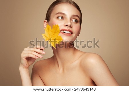 Similar – Image, Stock Photo Beautiful woman in autumn park wearing a burgundy beret, holding a red maple leaf. Young woman with long hair in stylish fall outfit, smiling and looking to the camera.