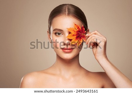 Similar – Image, Stock Photo A young woman makes a snow angel lying in the snow with her arms and legs spread to the sides