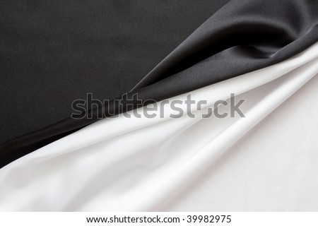 The beautiful silky brilliant black and white wavy fabric halved