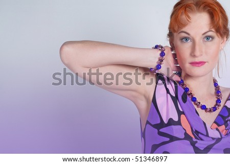 Portrait of the beautiful woman in a lilac dress