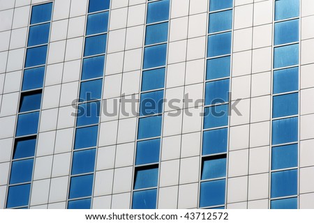 Wall of modern apartment skyscraper. Blue and white
