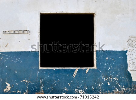 old cracked blue and white wall with empty window. good for your work