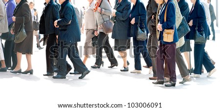 The big group of older persons.  People walking against a light background.
