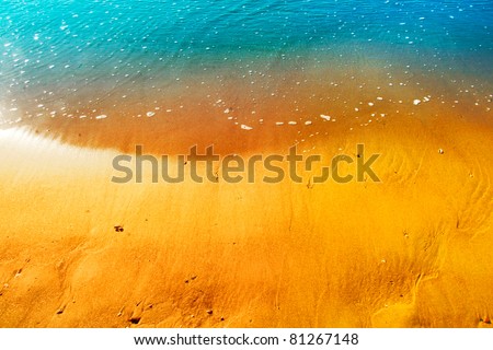 Gentle waves splash onto a golden shore