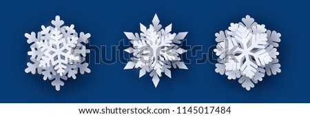 Vector set of 3 white Christmas paper cut 3d snowflakes with shadow on dark blue background. New year design elements