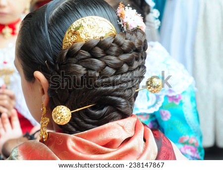 VALENCIA, SPAIN - NOVEMBER 9, 2014: traditional Valencian street party where inhabitants of all ages dance dressed in beautiful, original, handmade clothes and with typical hairstyle