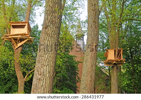 BRUGES, BELGIUM - MAY 16 2015: Tree huts in the beguinage, art by the Japanese Tadashi Kawamata for the first edition of Bruges triennial exhibition \'??Artwork in Progress\'?? till October 18
