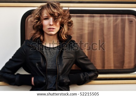 self-confident young woman standing near Camper