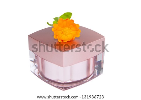 Jar with cosmetics on the basis of medicinal herbs and flower of calendula isolated on a white background.